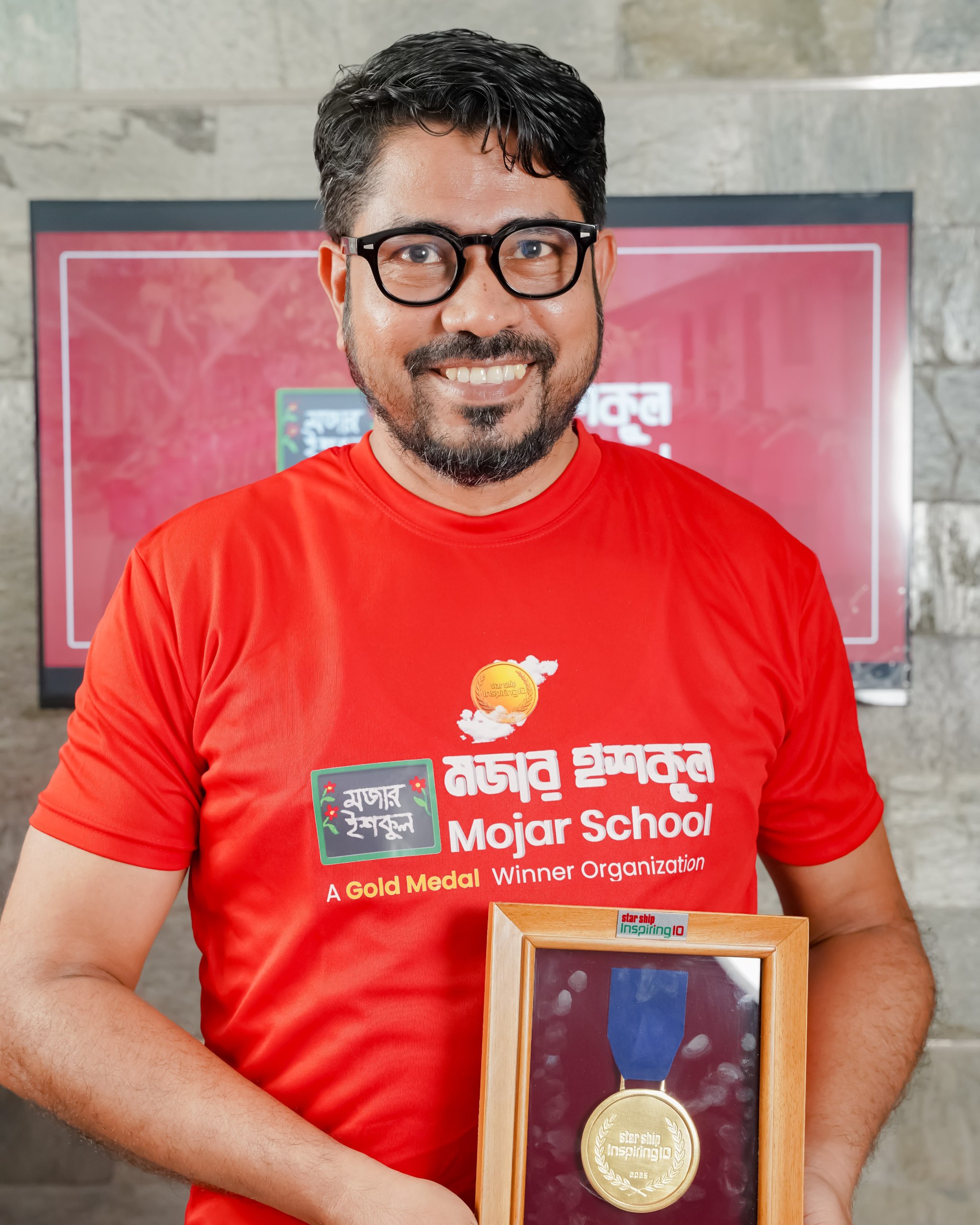Abdul Halim holding Gold Medal — Mojar School